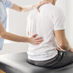 man with back pain getting physical therapy